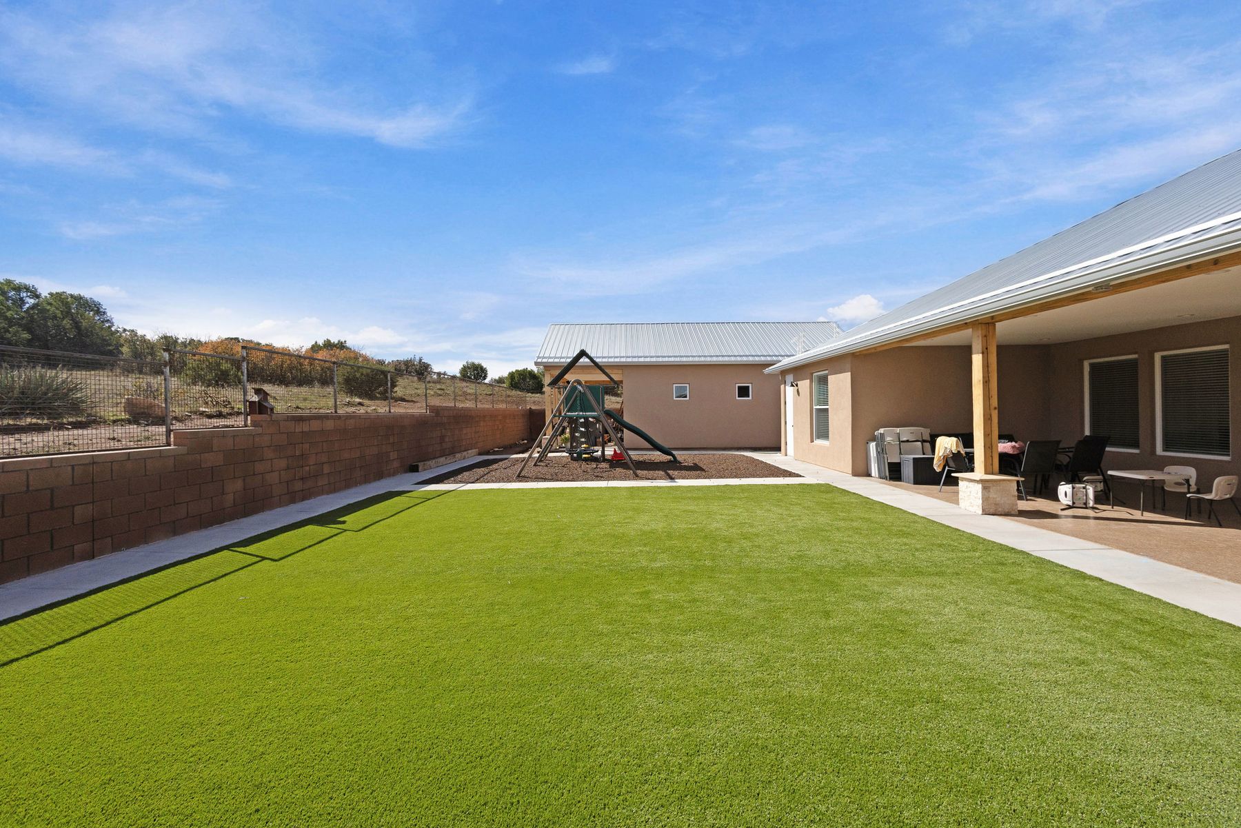 Tijeras — back yard with lawn and covered patio