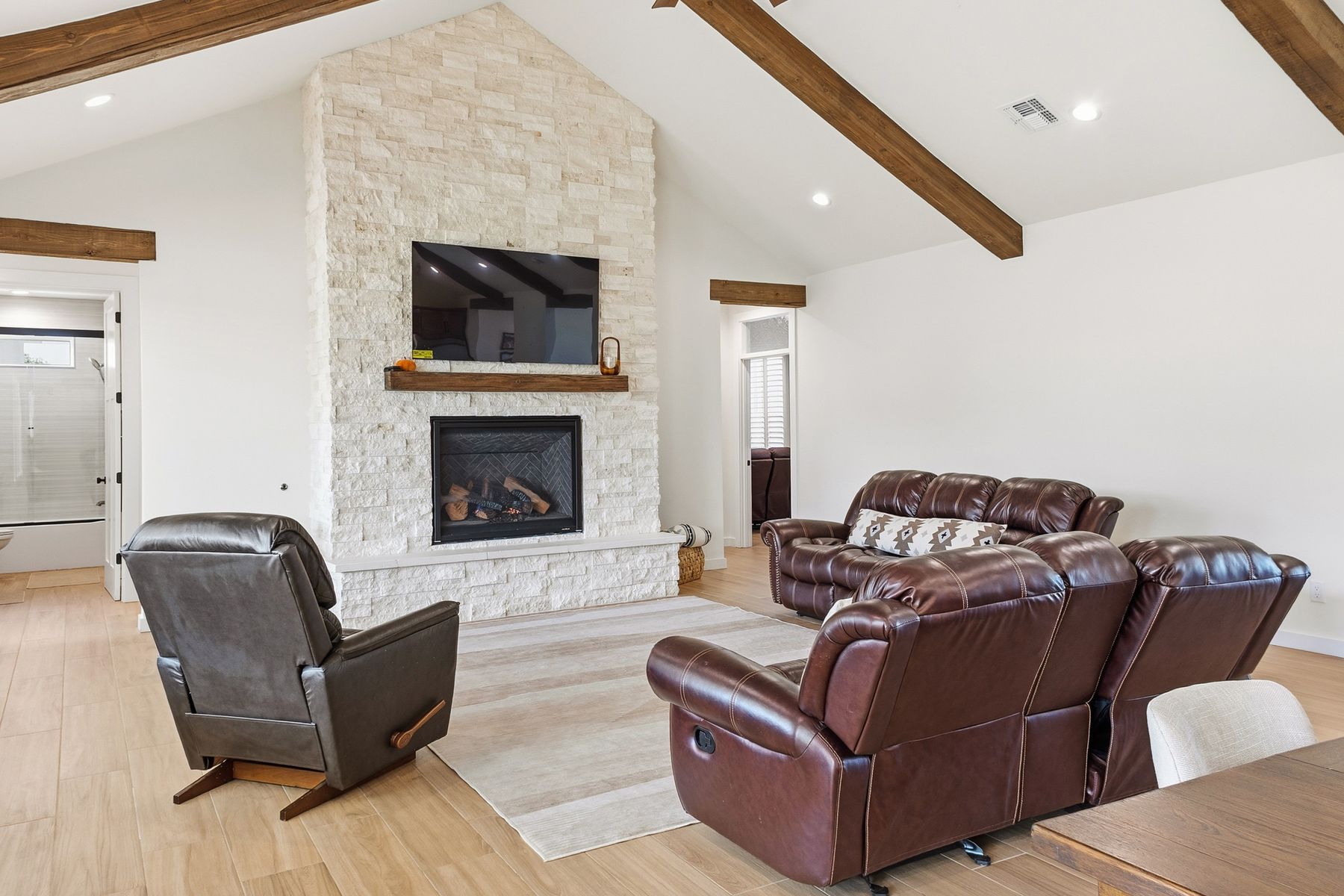 Tijeras — great room with stone fireplace and timber beams