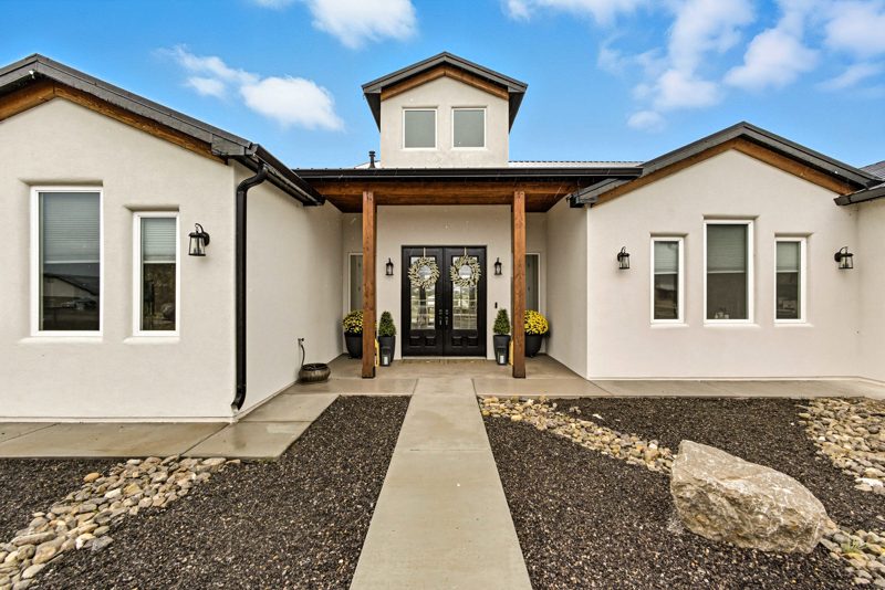 Custom home in Sandia Park with a timber-column entry